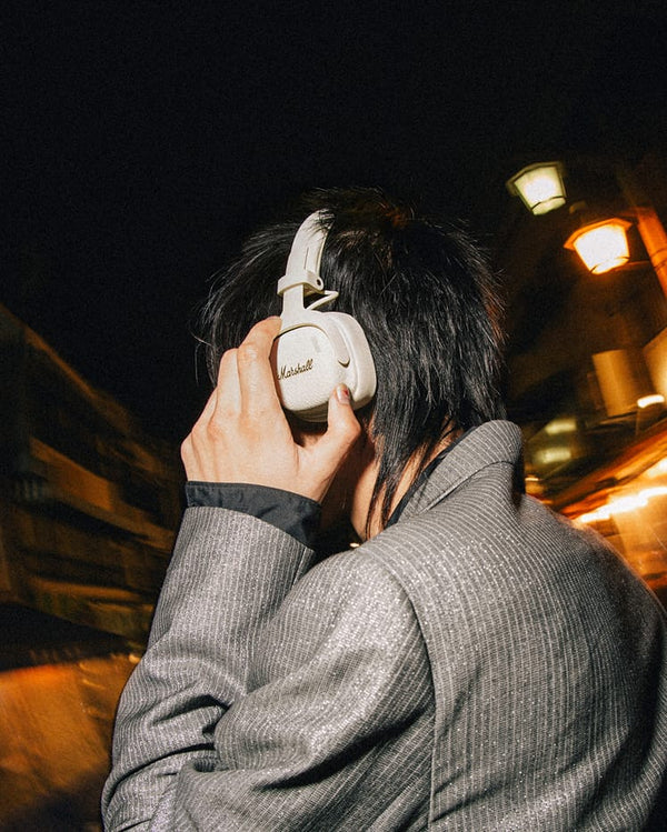 Marshall – Milton ANC - Wireless Headphones - Cream, white headphones worn from behind by a person with black hair