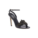 Elegant Mirales black high-heel ankle cross sandal featuring chic design and gold embellishments for a striking fashion statement.