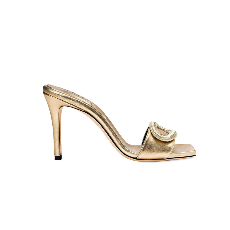 Naria Gold High-Heel Sandal with ornate oval embellishment and elegant Italian leather, showcasing a 90mm heel.