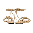 Elegant antique gold Ophilia lace-up sandals featuring braided straps designed to be worn loose or tight.
