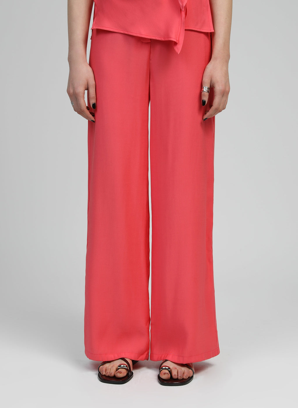 An'ge – Pantalon Phoebila Corail, pantalon large corail porté par un mannequin, vue de face