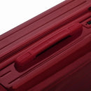 Poignée supérieure rigide de la valise GYL Intemporelle orange avec logo embossé sur le dessus. #couleur_rouge foncé