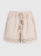 An'ge – Short Ramalo Lin, short beige en lin avec broderies et perles, vue de face