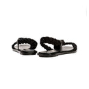Ronda Black Flat Asymmetric Sandal with braided straps and sleek black leather sole, perfect for summer adventures.