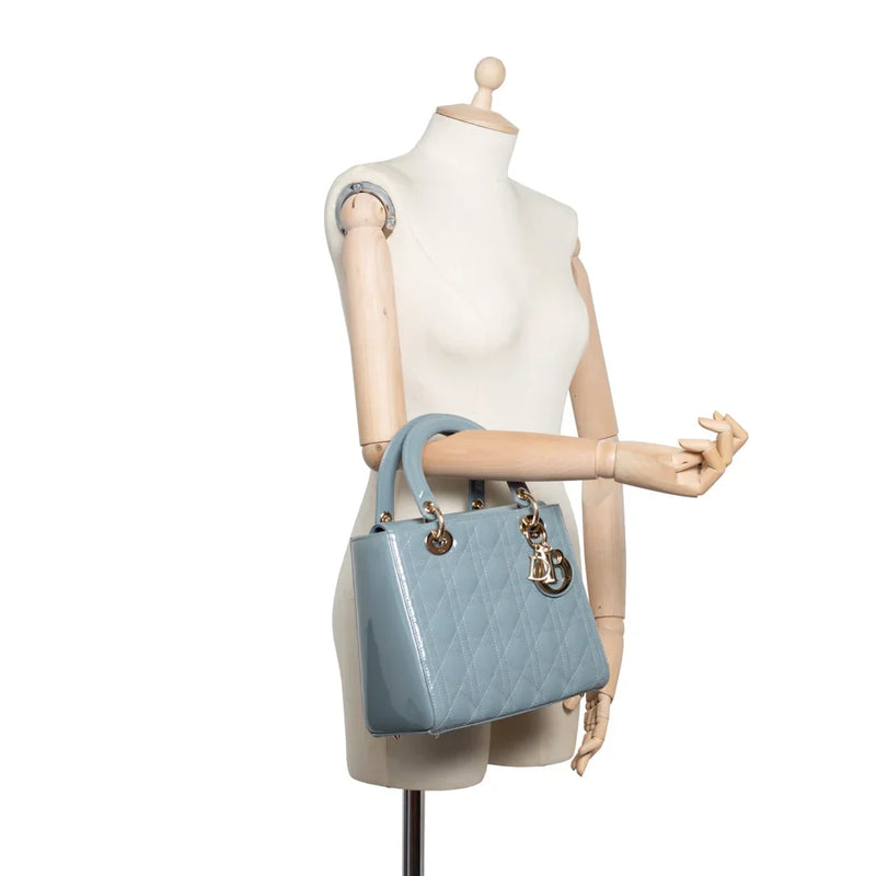 sac de seconde main lady  dior en cuir verni bleu porté 2