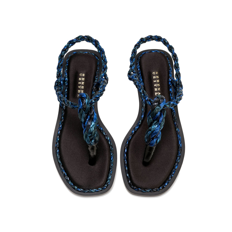 Thory Navy Flat Sandal featuring silk satin and navy raffia braiding, offering elegance in a minimal design.