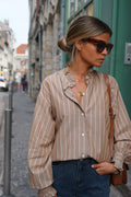 The camel and beige striped Garance blouse is a timeless piece for all seasons 