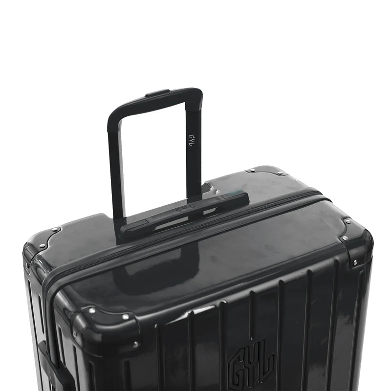 Poignée trolley télescopique GYL déployée sur la valise Intemporelle gris foncé en polycarbonate. #couleur_gris foncé