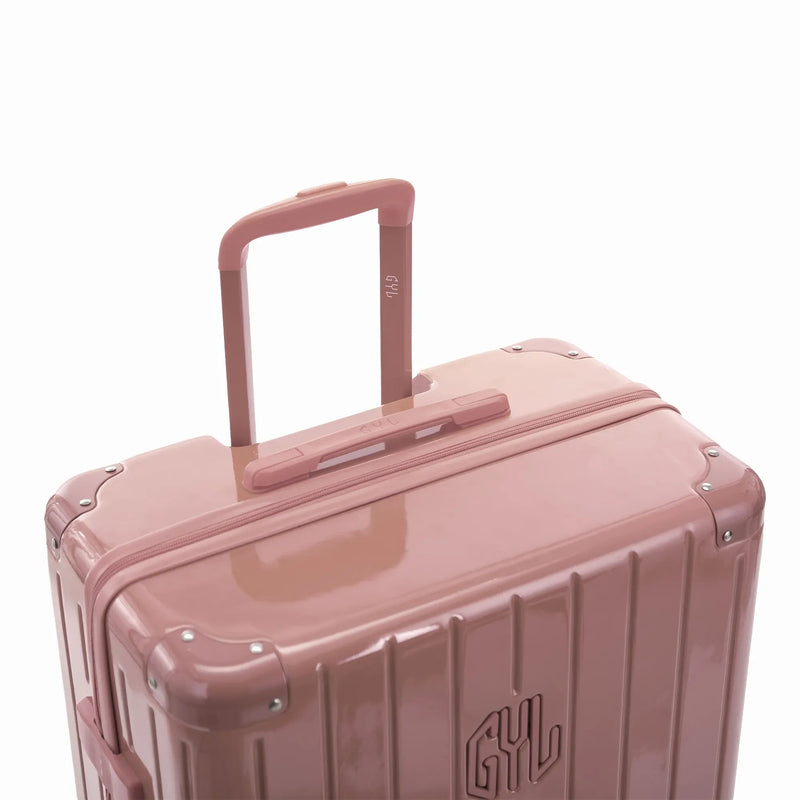 Poignée trolley télescopique GYL déployée sur la valise Intemporelle rose gold en polycarbonate. #couleur_rose gold