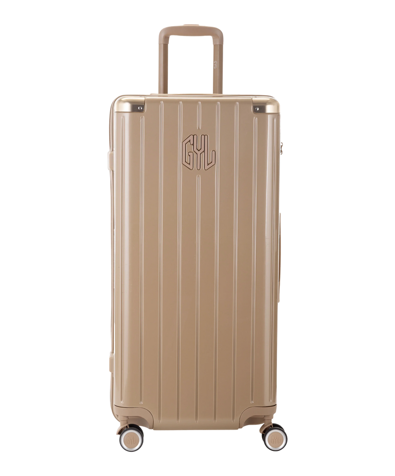 Valise Trunk GYL en polycarbonate Trunk XL 80 cm coloris champagne vue de face avec logo GYL