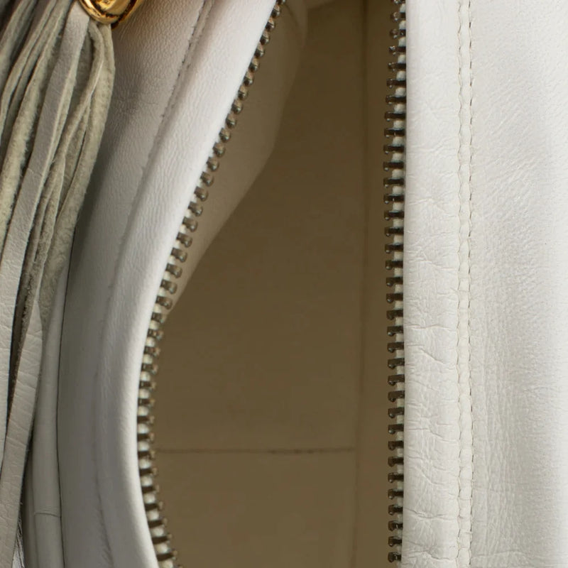 sac de seconde main camera chanel en cuir blanc intérieur